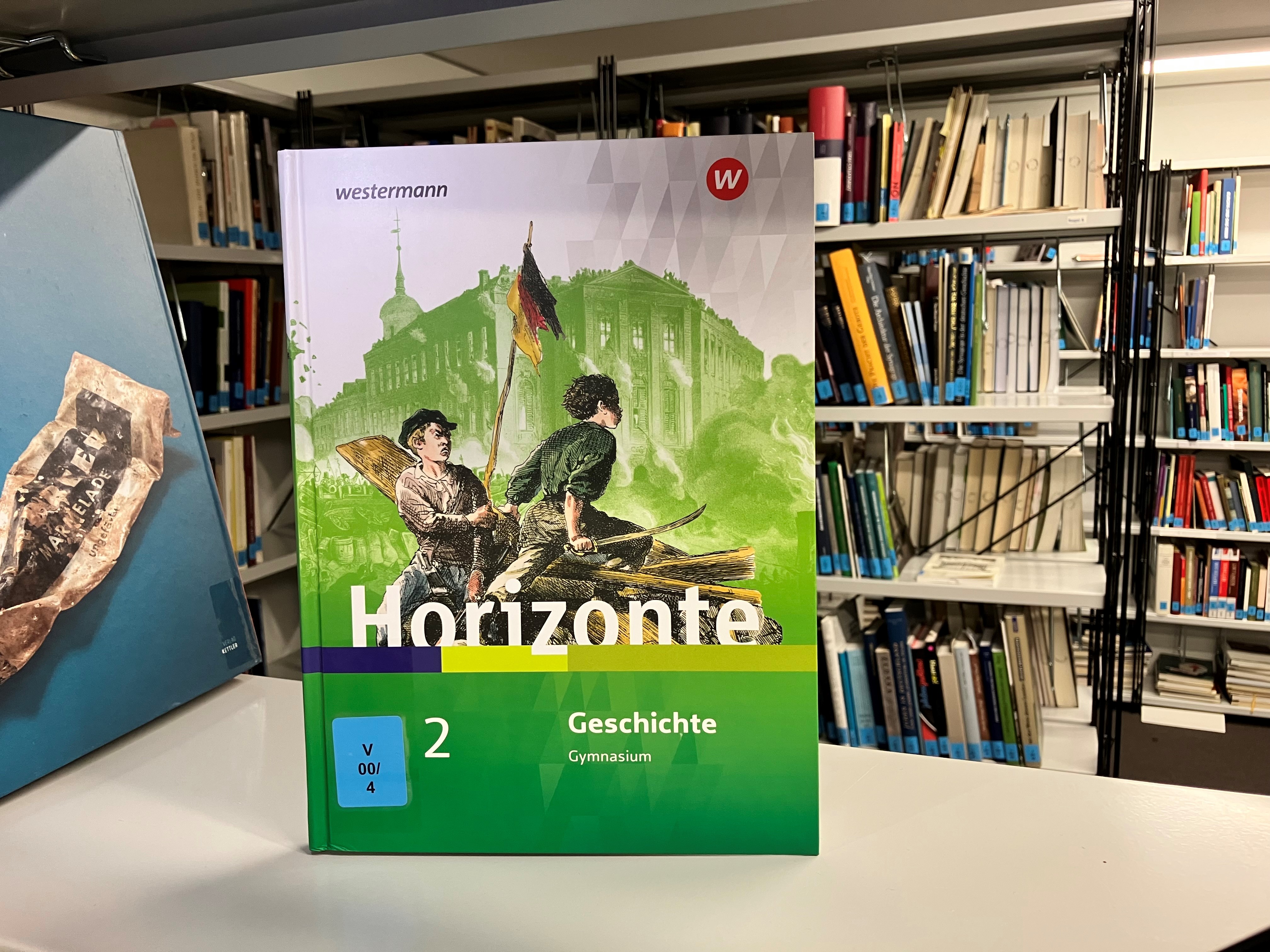 Ein Sachbuch für das Fach Geschichte fürs Gymnasium, auf dem "Horizonte" steht. Auf dem Titelblatt sind zwei Männer im Kampf zu sehen die eine Flagge hochhalten. 