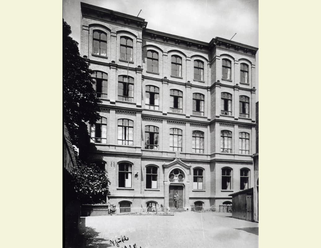 b/w photo facade of a four-story school building