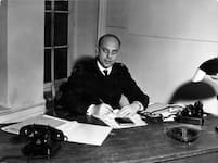 b/w: Walter Fließ sits at his desk